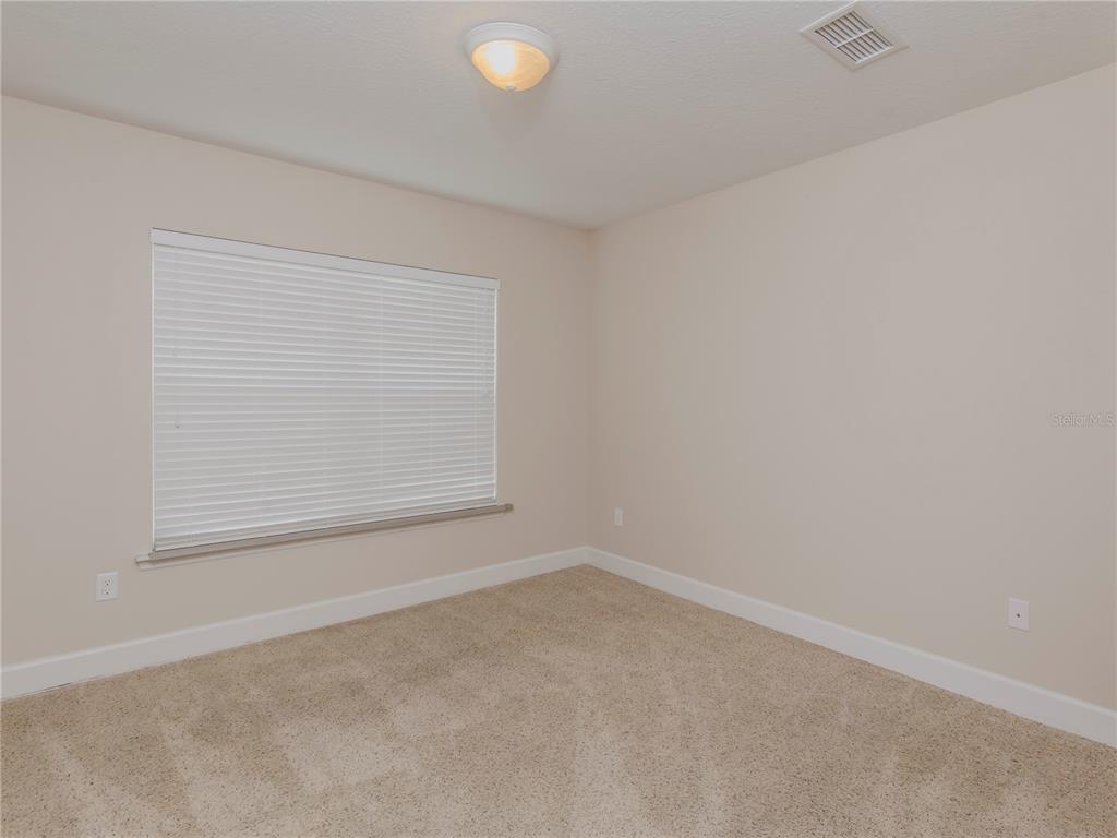 1642 Northwest 34th Avenue Gainesville, FL 32605 - Photo 12 of 14 an empty room with a window