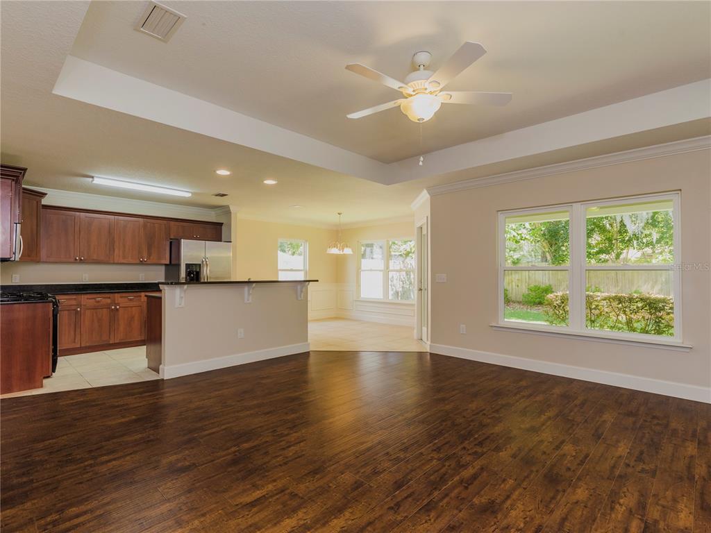 1642 Northwest 34th Avenue Gainesville, FL 32605 - Photo 2 of 14 a view of an empty room with wooden floor and a window