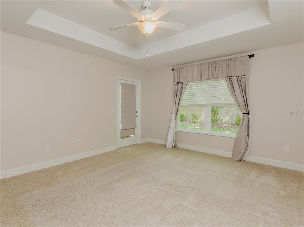 1642 Northwest 34th Avenue Gainesville, FL 32605 - Photo 6 of 14 an empty room with a window and a ceiling fan