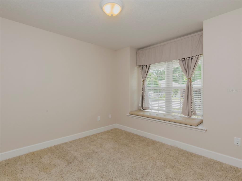 1642 Northwest 34th Avenue Gainesville, FL 32605 - Photo 9 of 14 an empty room with a window