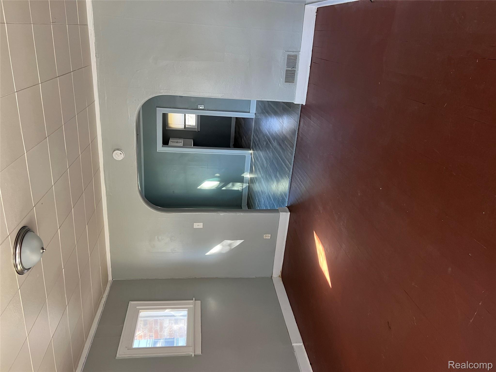 936 Stocker Avenue Flint, MI 48503 - Photo 3 of 15 Unfurnished room featuring ornamental molding, arched walkways, and a paneled ceiling