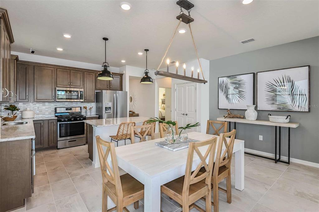 2364 Daisy Tree Road St. Cloud, FL 34771 - Photo 13 of 31 a large kitchen with a table and chairs