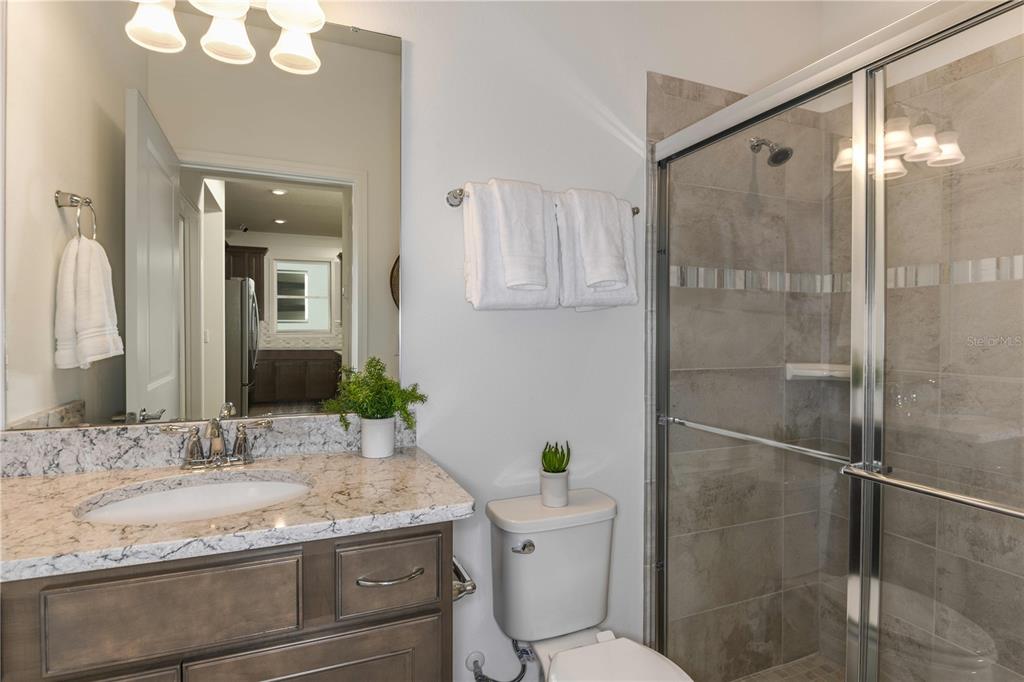 2364 Daisy Tree Road St. Cloud, FL 34771 - Photo 25 of 31 a bathroom with a granite countertop sink toilet and shower