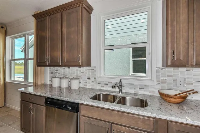 a kitchen with a stove a sink a counter top space and a center island