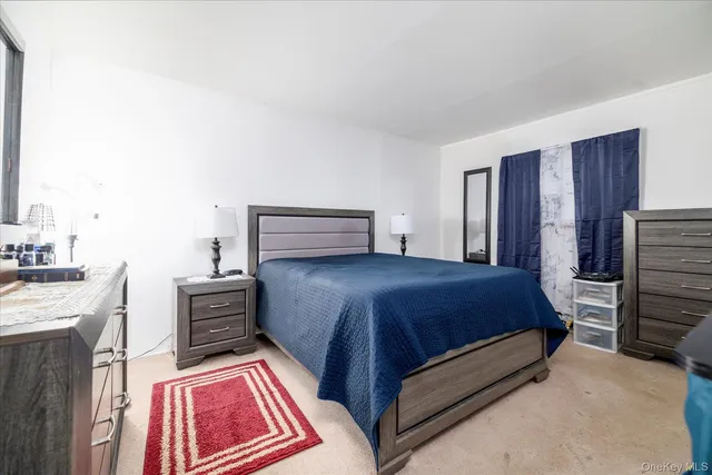 a bedroom with a bed and dresser