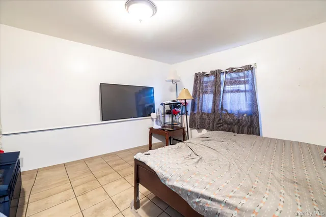 a bed sitting in a bedroom next to a large window