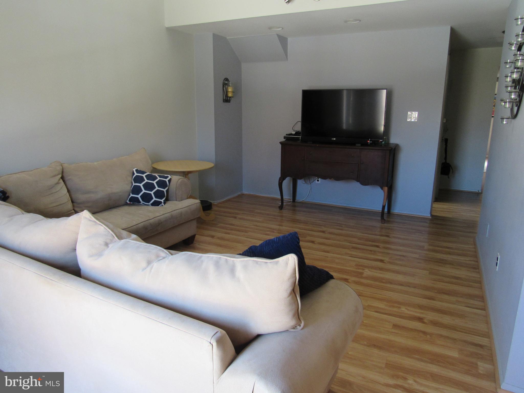 9585 James Street, Unit B Philadelphia, PA 19114 - Photo 5 of 26 a living room with furniture and a flat screen tv
