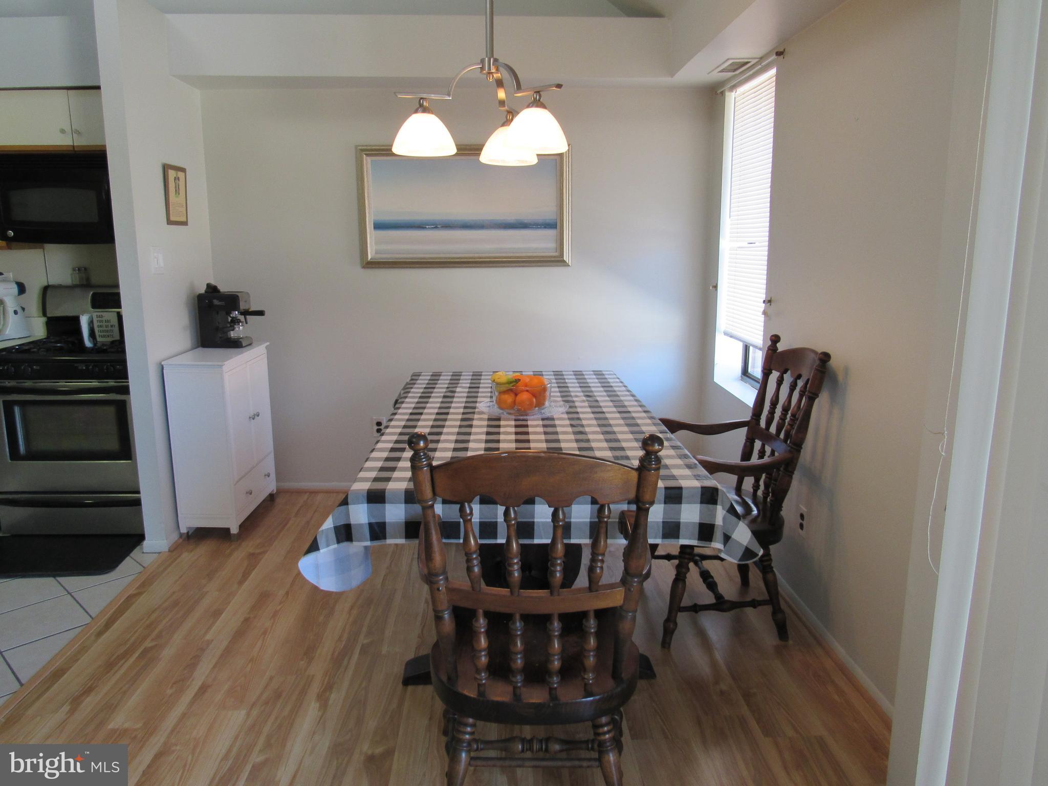 9585 James Street, Unit B Philadelphia, PA 19114 - Photo 7 of 26 a view of a dining room with furniture and wooden floor