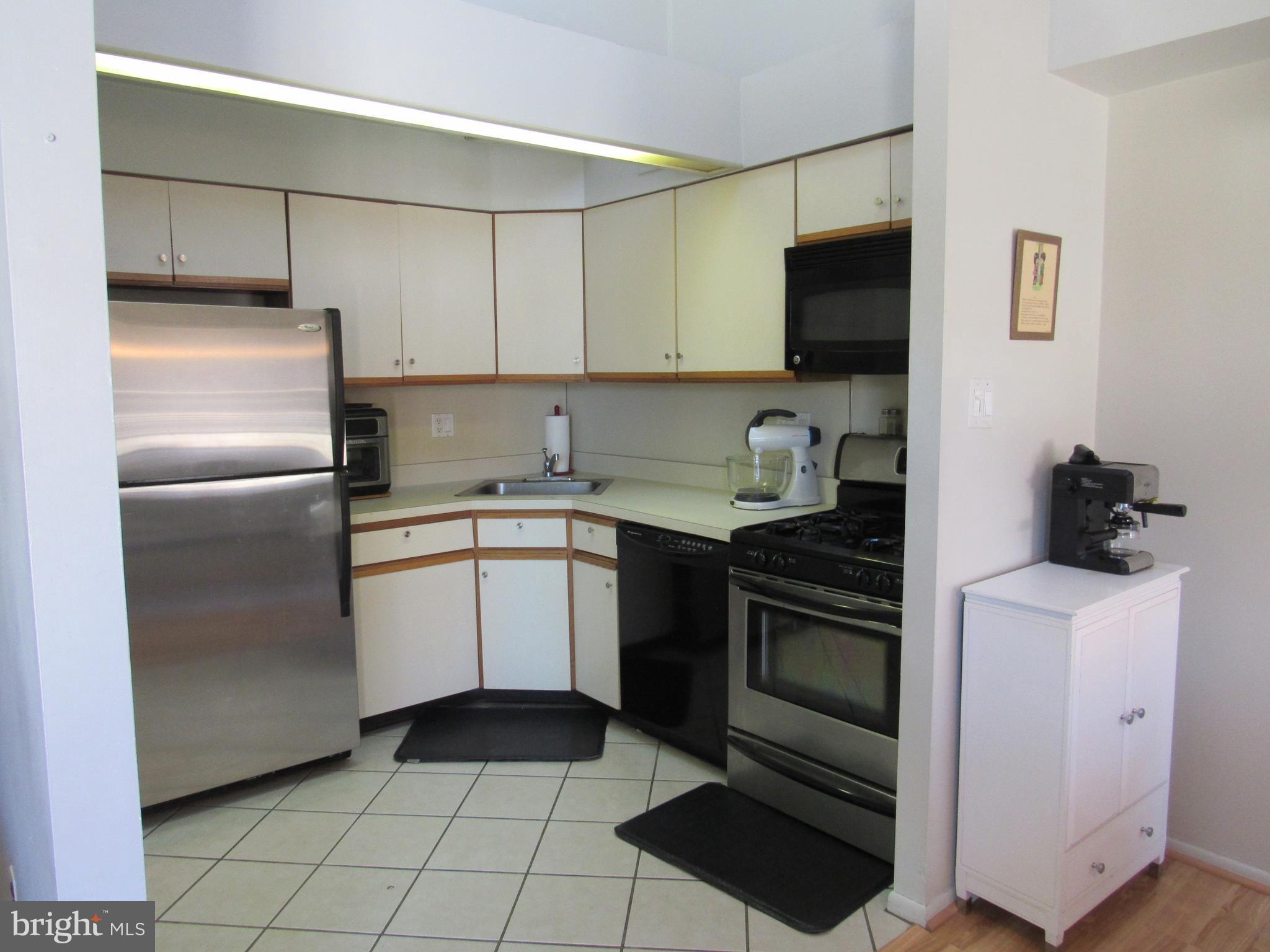 9585 James Street, Unit B Philadelphia, PA 19114 - Photo 9 of 26 a kitchen with a sink stove and refrigerator