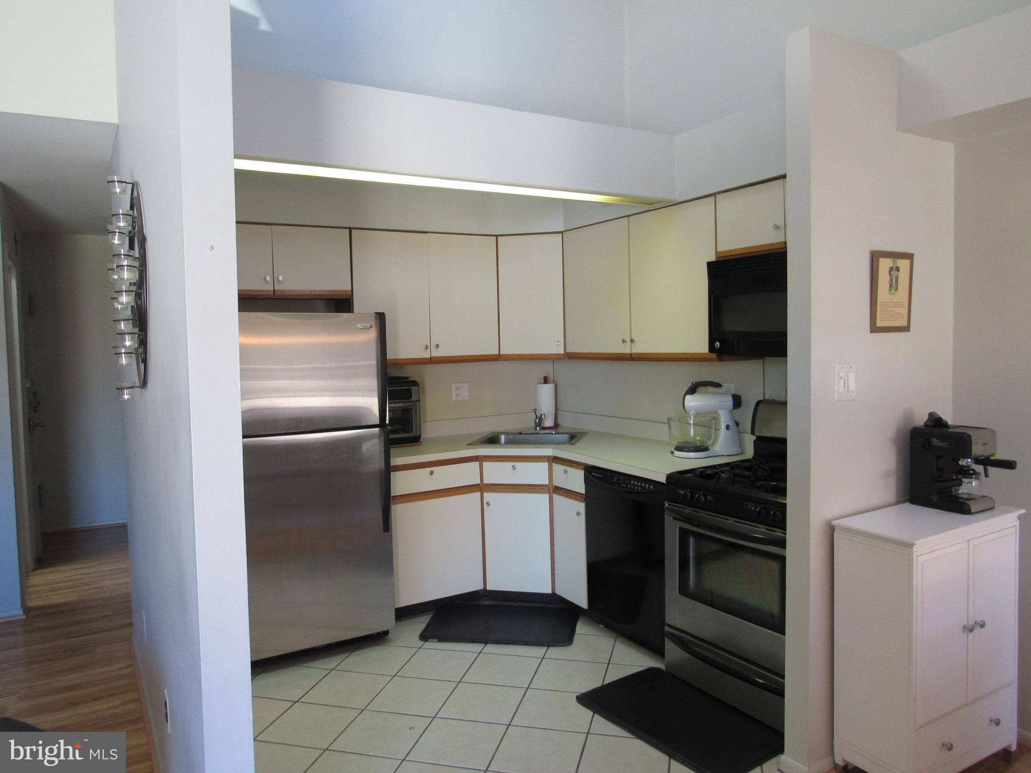 9585 James Street, Unit B Philadelphia, PA 19114 - Photo 10 of 26 a kitchen with a sink appliances and cabinets