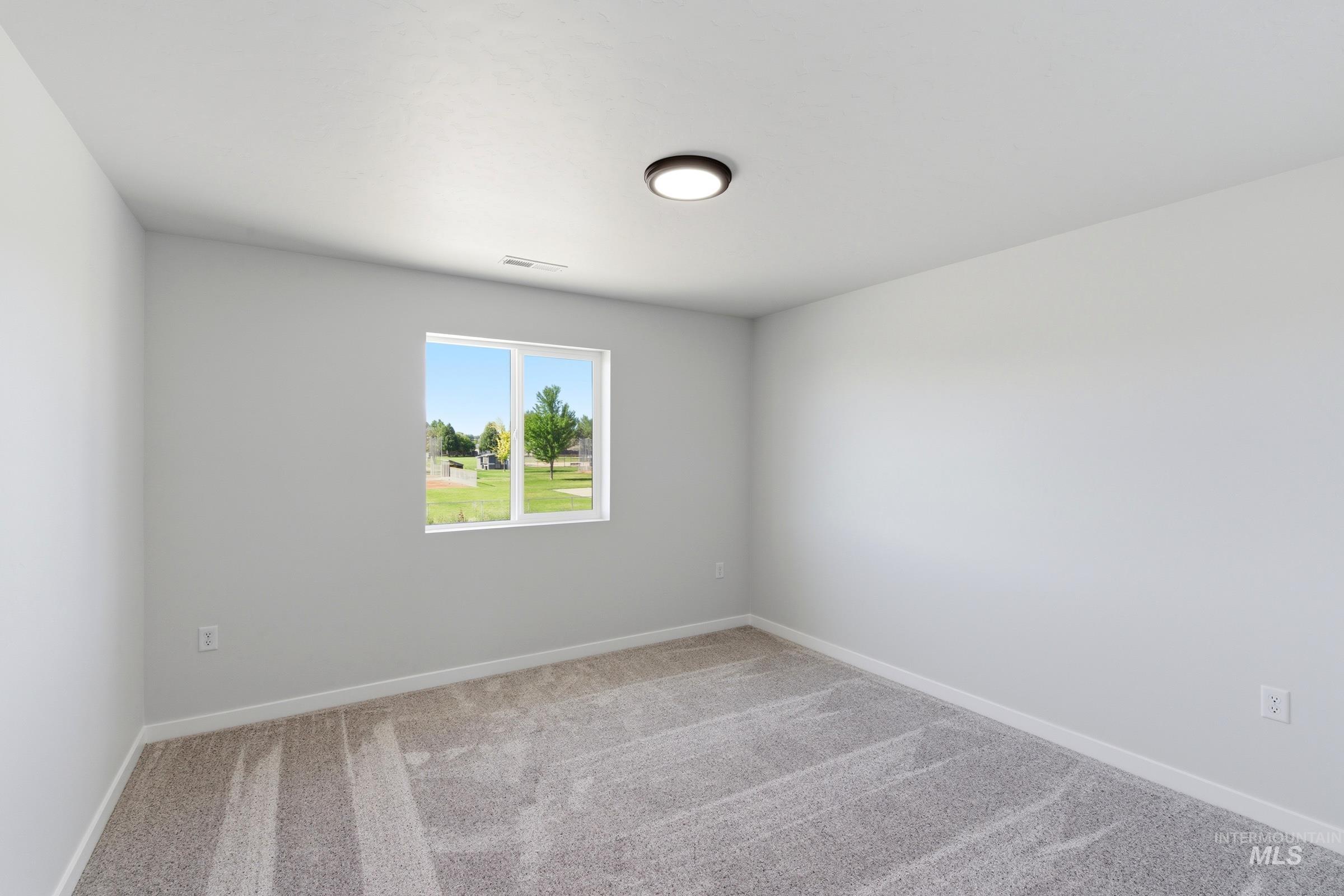 13677 Redway Court Caldwell, ID 83607 - Photo 23 of 35 Bright interior space featuring light gray walls, white trim, and a neutral-toned carpet