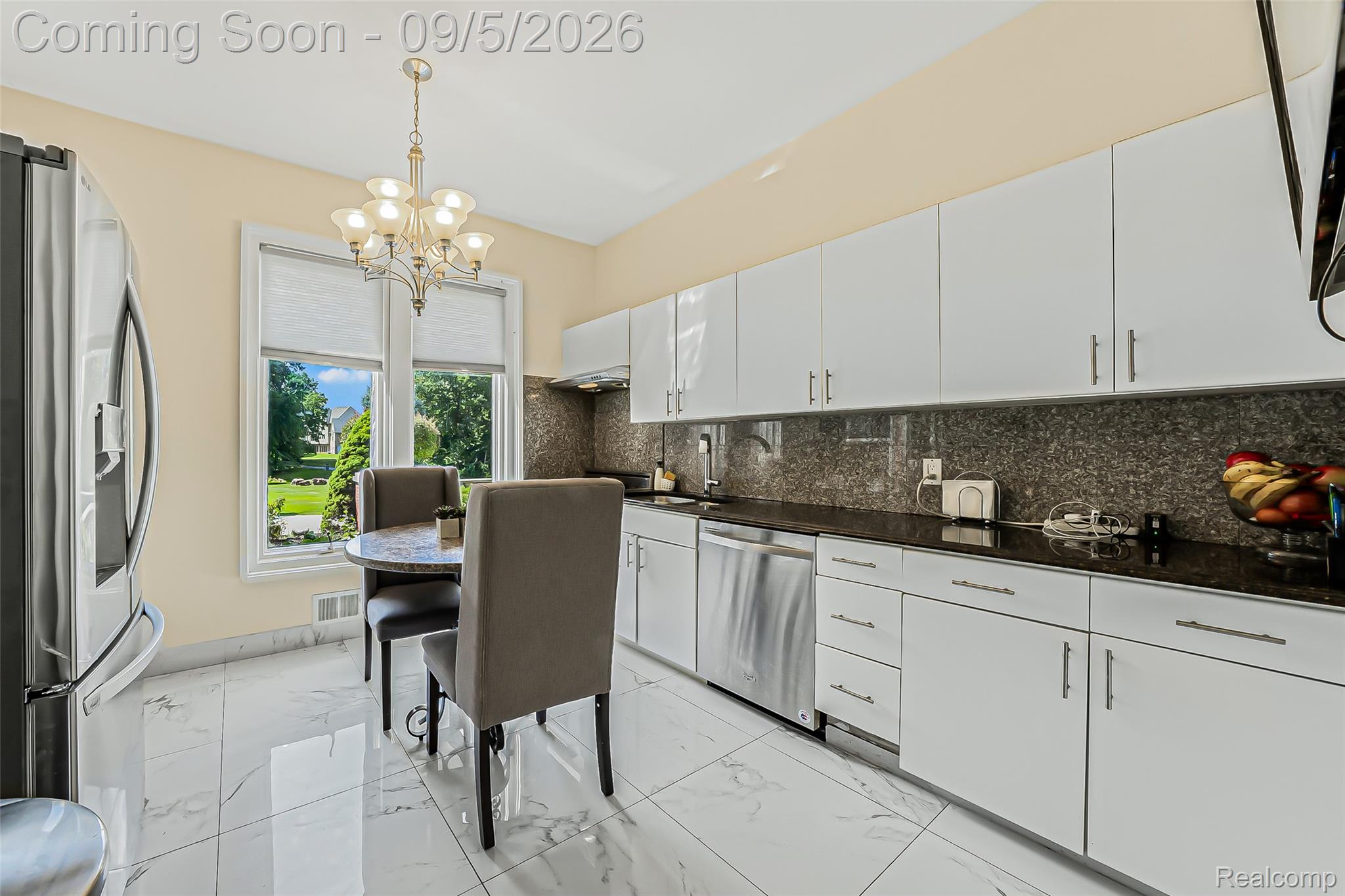 2785 Cranbrook Ridge Court Rochester, MI 48306 - Photo 55 of 97 Kitchen featuring white high-gloss cabinetry, dark stone countertops, stainless steel appliances, and large format tile flooring