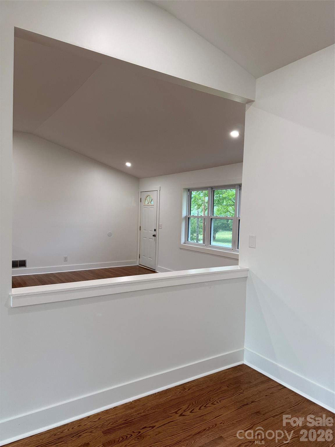 2677 Pax Hill Road Morganton, NC 28655 - Photo 11 of 15 a view of an empty room with wooden floor and a window
