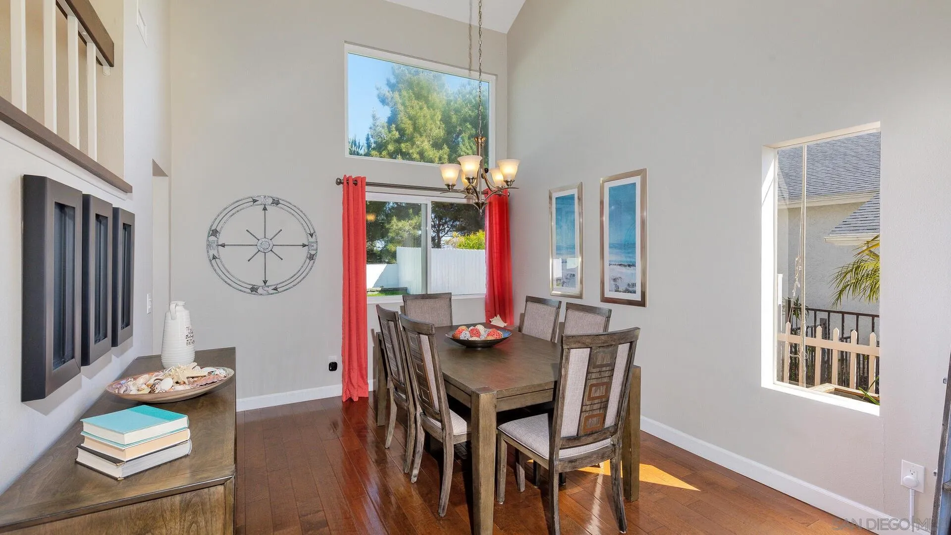 388 Compass Road Oceanside, CA 92054 - Photo 3 of 15 a view of a dining room with furniture a chandelier and wooden floor