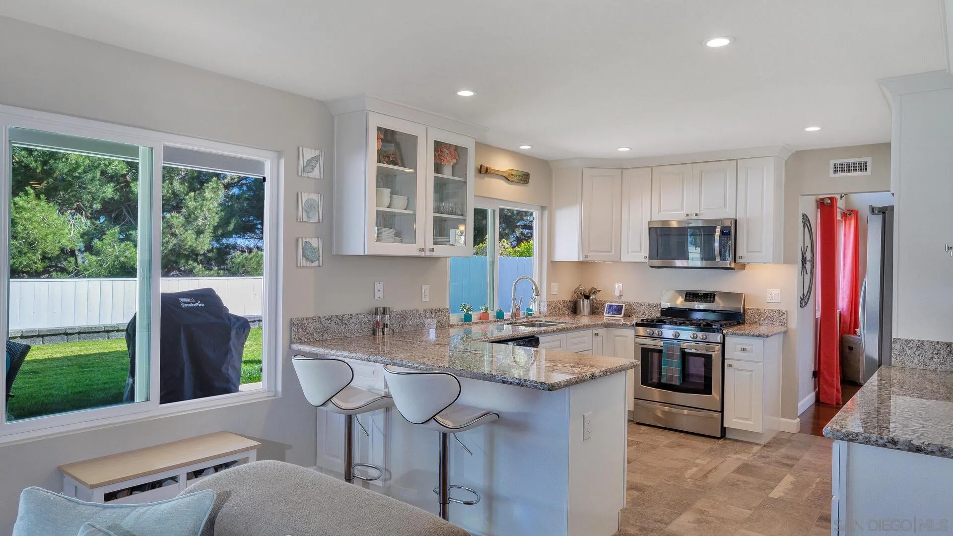 388 Compass Road Oceanside, CA 92054 - Photo 7 of 15 a kitchen with stainless steel appliances granite countertop a stove a sink a refrigerator and a microwave