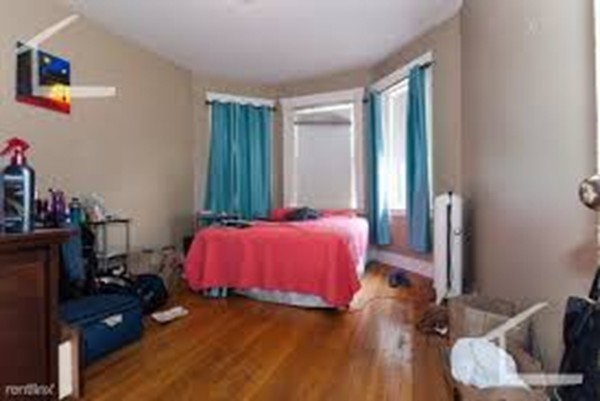 72 Strathmore Road, Unit 10 Boston, MA 02135 - Photo 4 of 9 a bedroom with a bed and a window