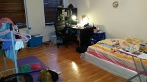 72 Strathmore Road, Unit 10 Boston, MA 02135 - Photo 5 of 9 a bedroom with bed and a mirror