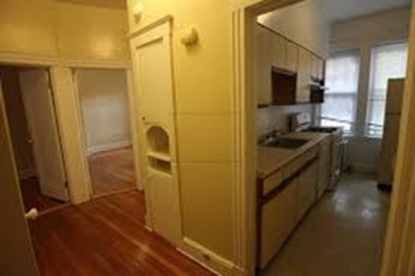 72 Strathmore Road, Unit 10 Boston, MA 02135 - Photo 6 of 9 a kitchen with a refrigerator and a stove