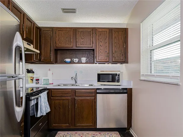 a kitchen with a sink and a microwave
