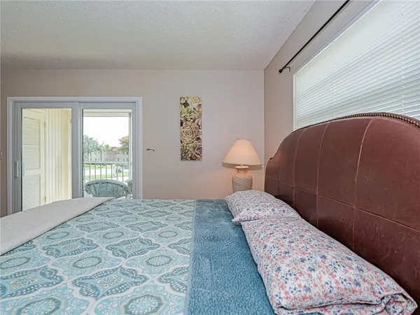 a bedroom with a large bed and a dresser