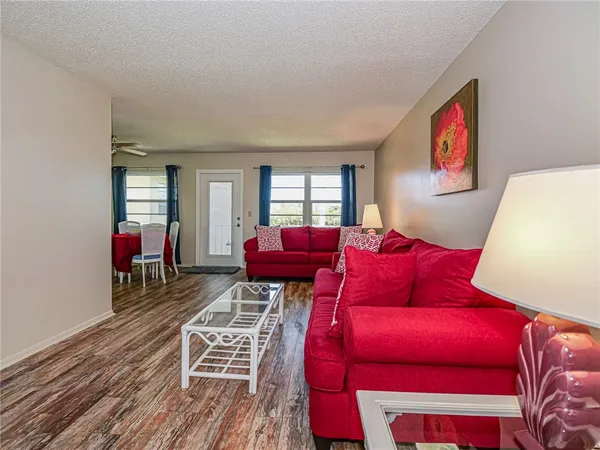 a dining room with furniture window and wooden floor