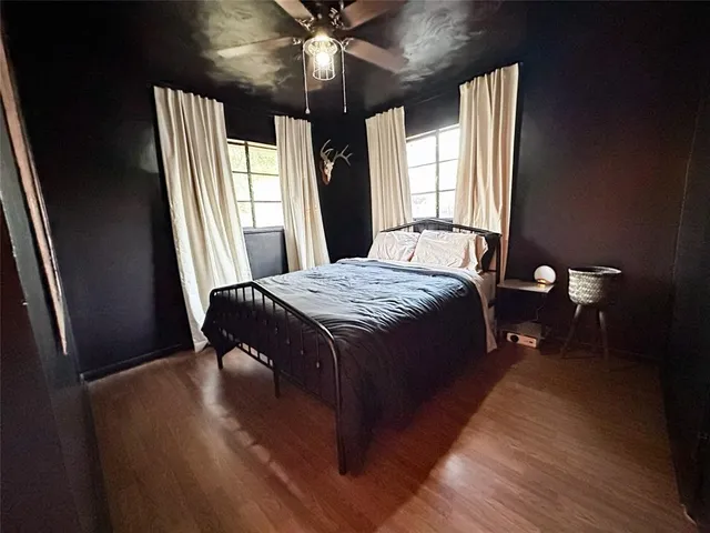 a bed sitting in a bedroom next to a window