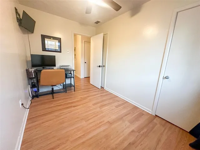 a workspace with wooden floor and furniture