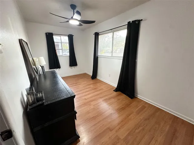 a view of a livingroom with furniture window and wooden floor