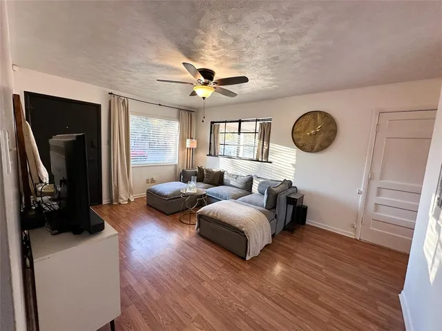 a bedroom with furniture and a large window