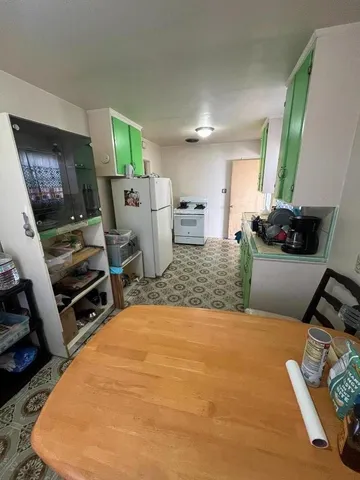 a living room with furniture a flat screen tv and a table