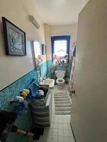 a dining room with furniture and a potted plant