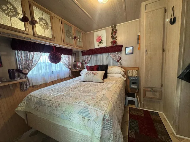 a bedroom with furniture and a flat screen tv