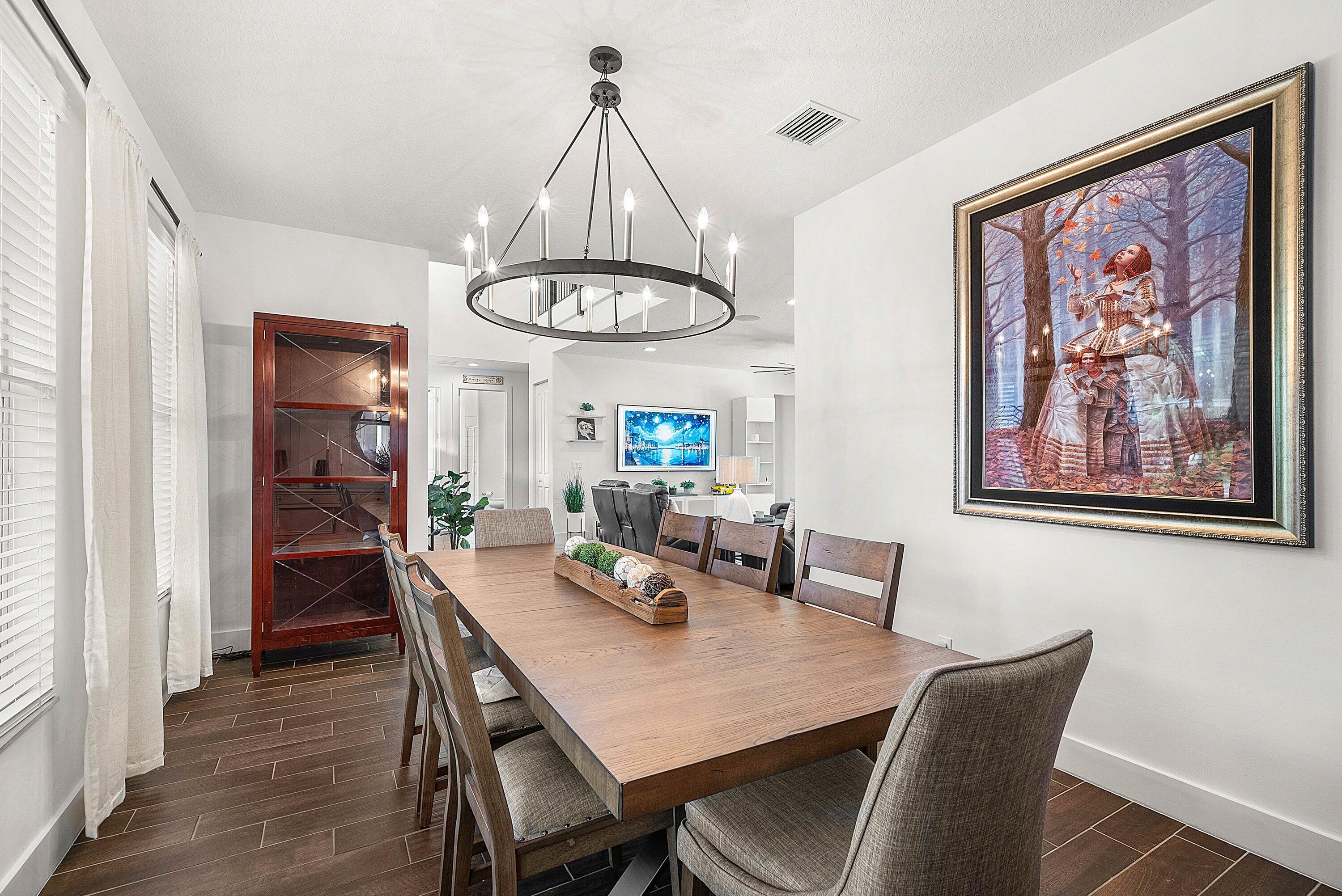 1107 Timber Reap Trail Loxahatchee, FL 33470 - Photo 15 of 83 a view of a dining room with furniture wooden floor and a chandelier