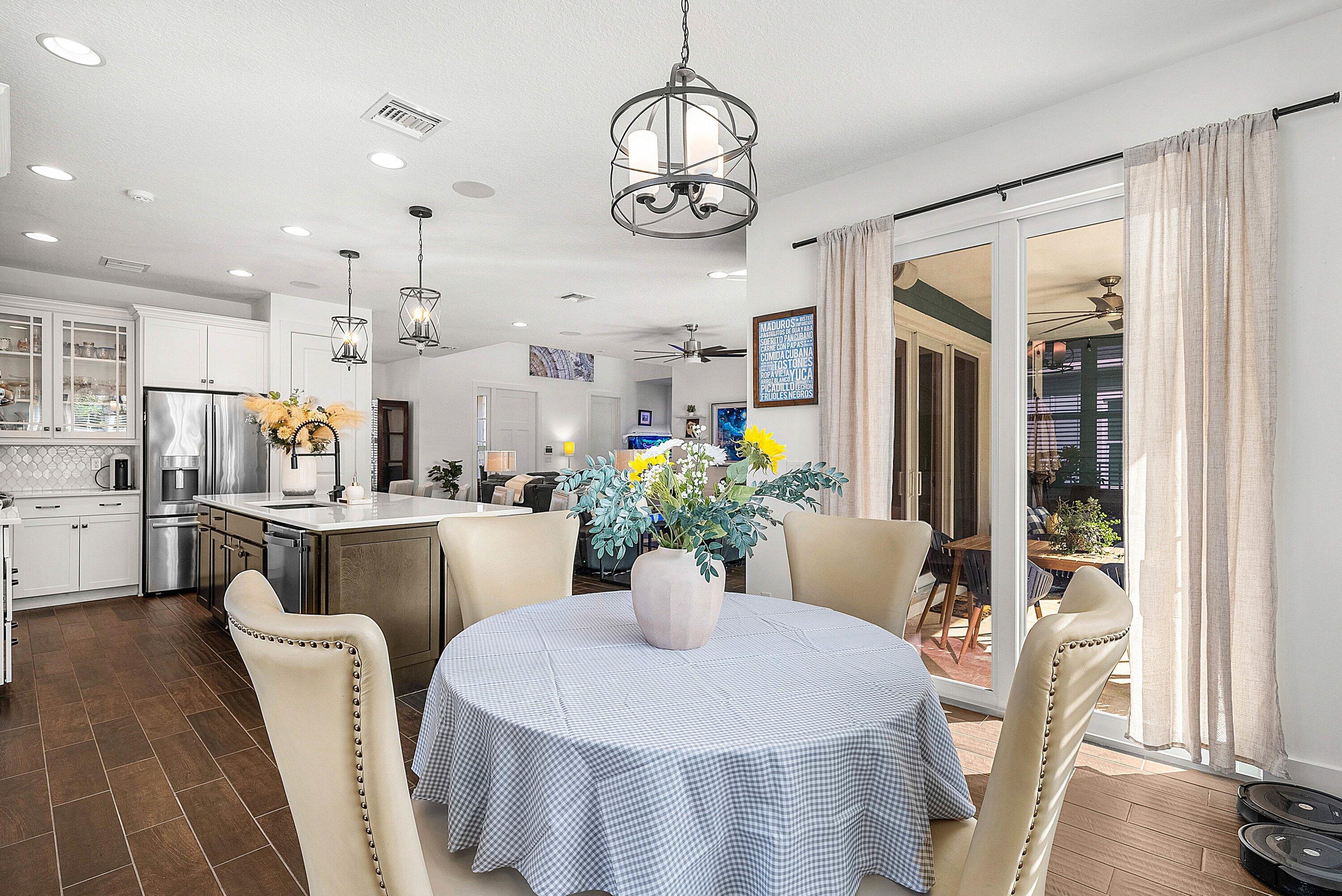 1107 Timber Reap Trail Loxahatchee, FL 33470 - Photo 17 of 83 a dining room with furniture potted plants and wooden floor