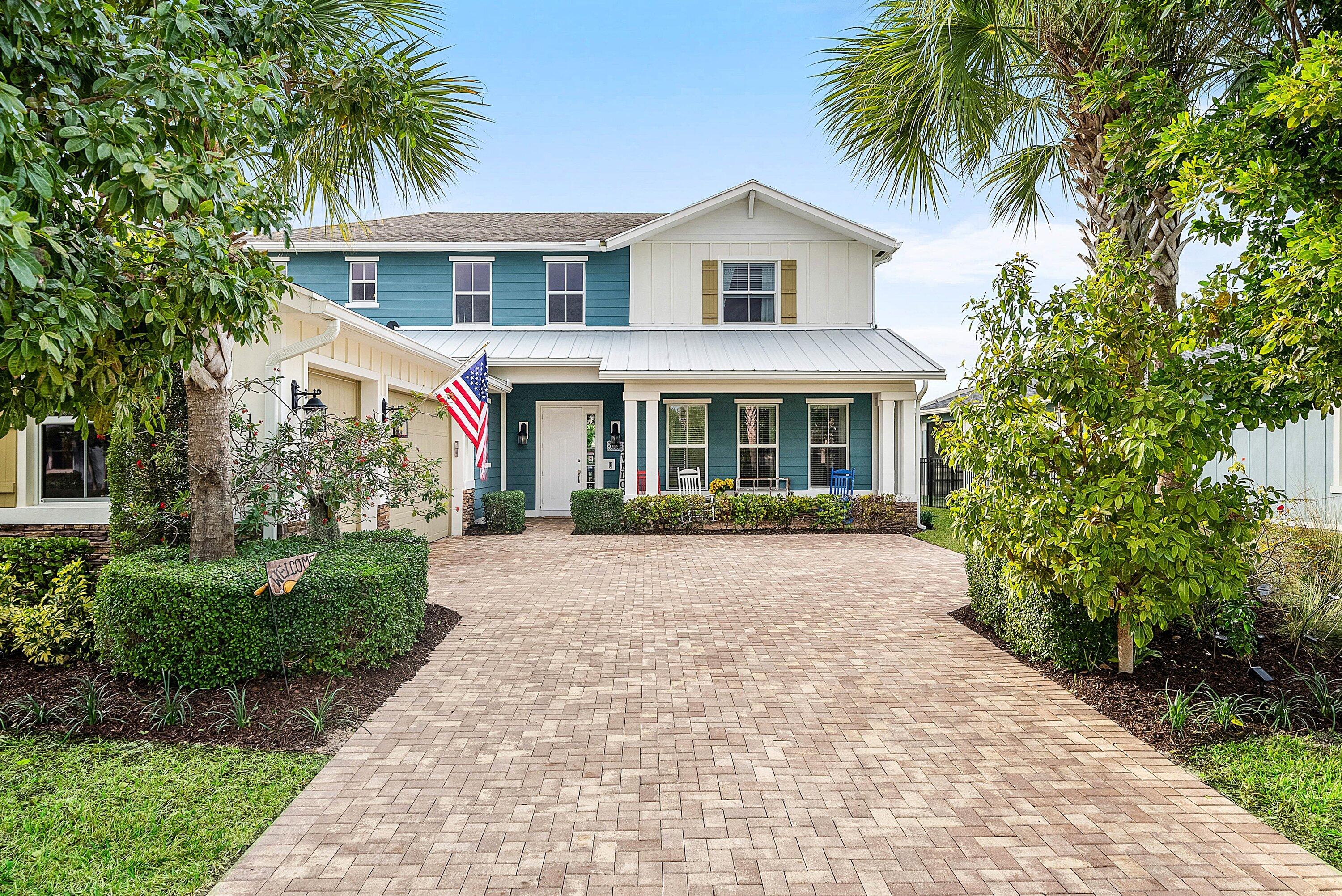 1107 Timber Reap Trail Loxahatchee, FL 33470 - Photo 2 of 83 a front view of a house with a garden and palm trees