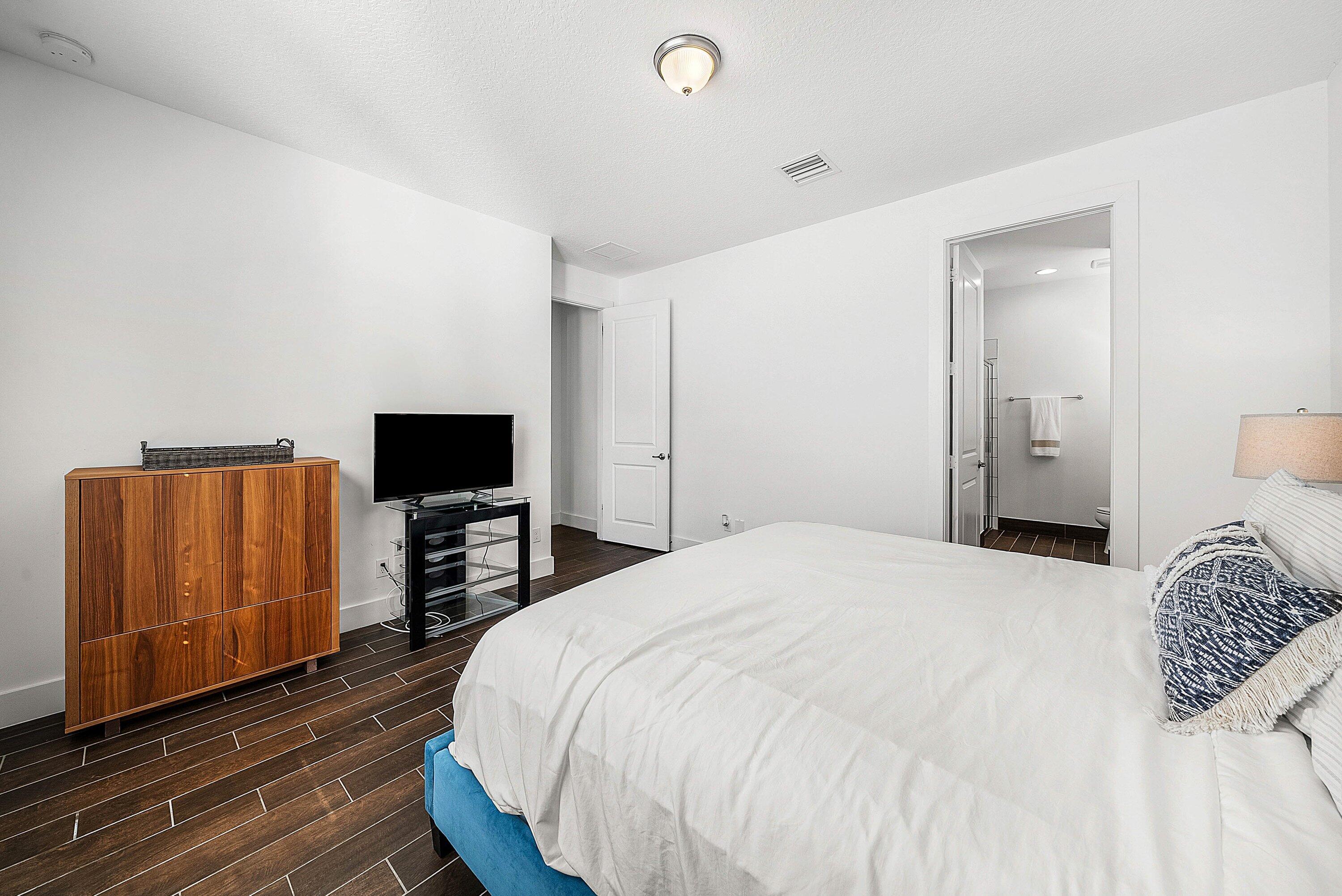 1107 Timber Reap Trail Loxahatchee, FL 33470 - Photo 21 of 83 a bedroom with a bed and a television