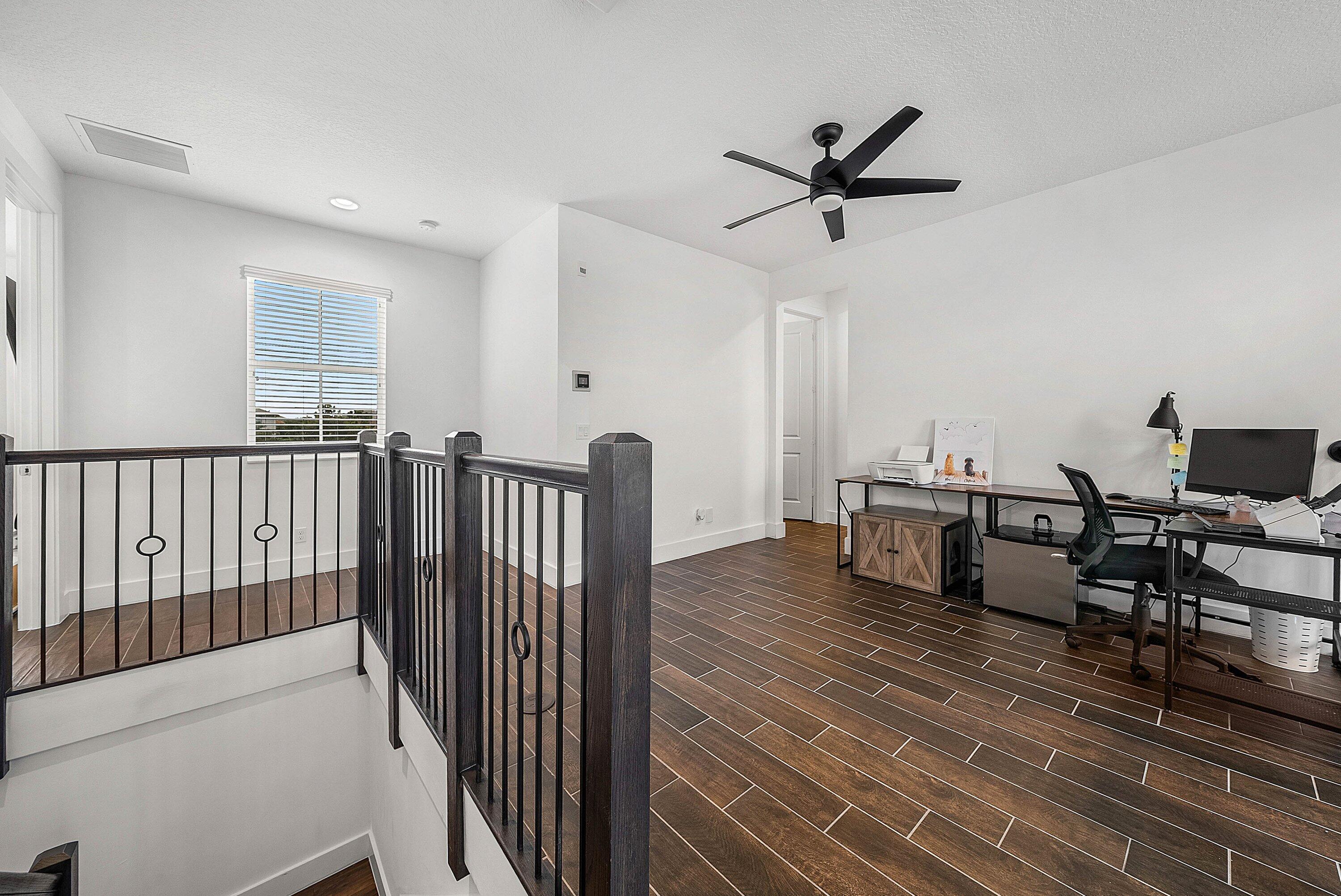 1107 Timber Reap Trail Loxahatchee, FL 33470 - Photo 25 of 83 a view of a livingroom with wooden floor and a ceiling fan