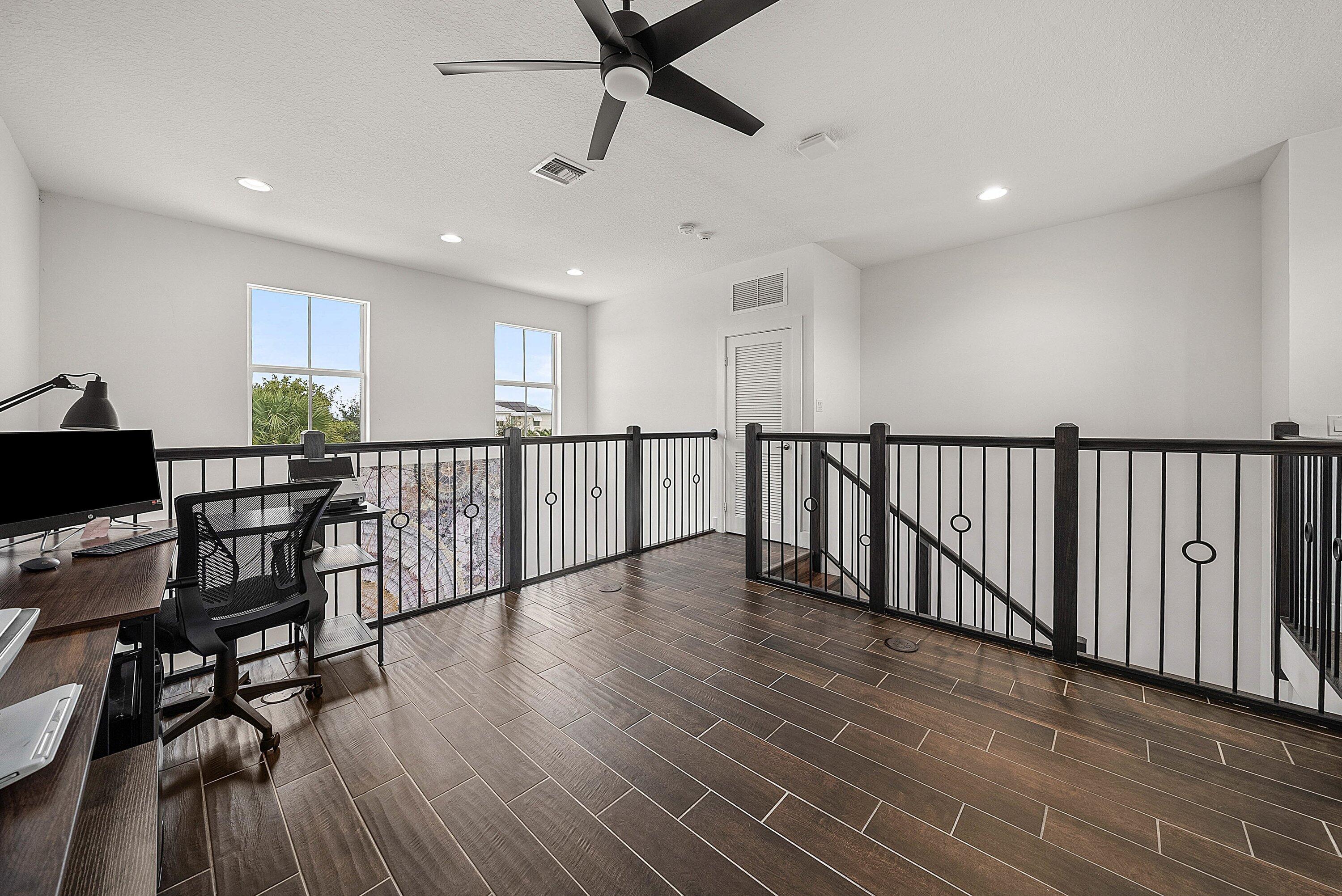 1107 Timber Reap Trail Loxahatchee, FL 33470 - Photo 26 of 83 a view of a room with wooden floor and windows
