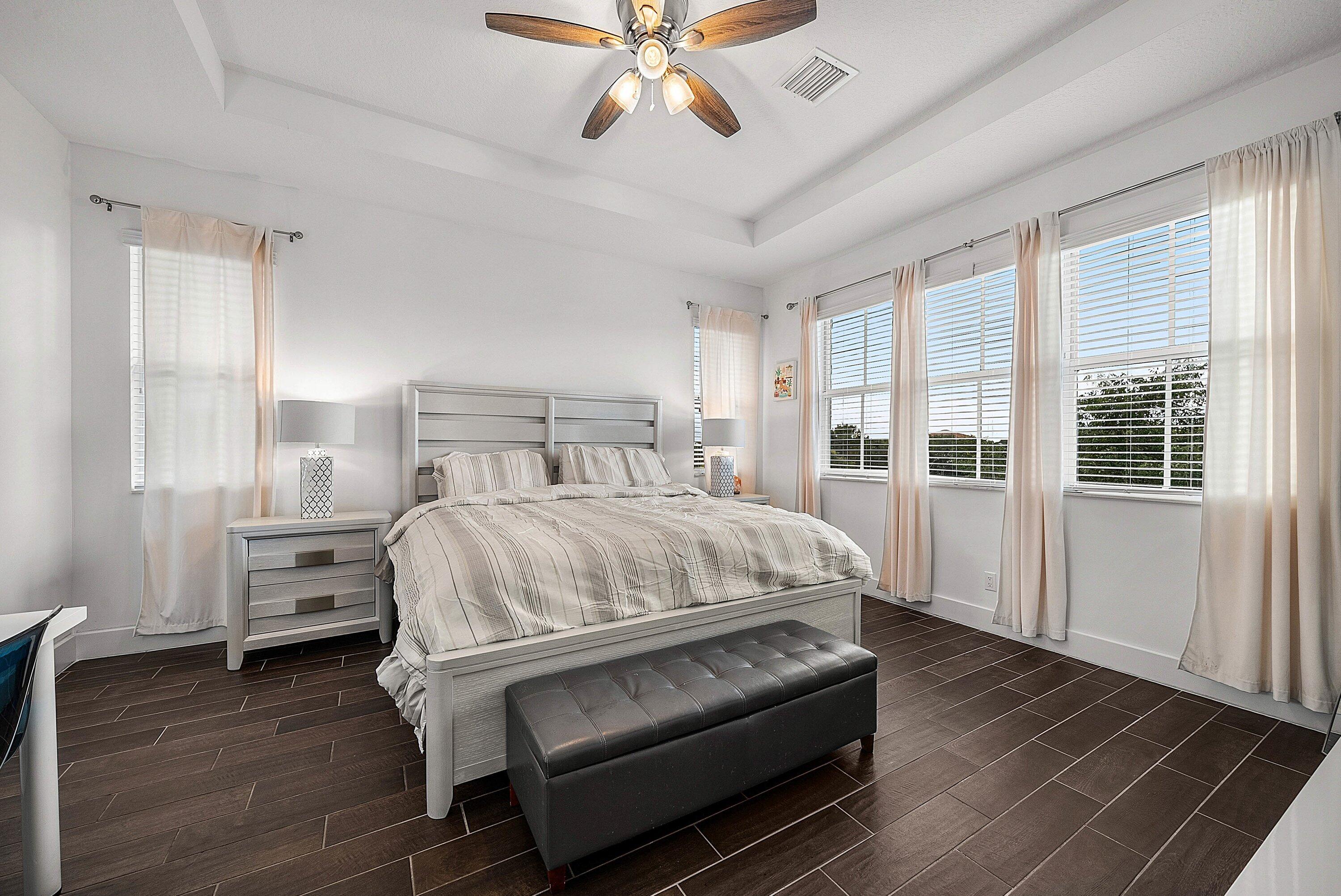 1107 Timber Reap Trail Loxahatchee, FL 33470 - Photo 27 of 83 a bedroom with a bed and wooden floor