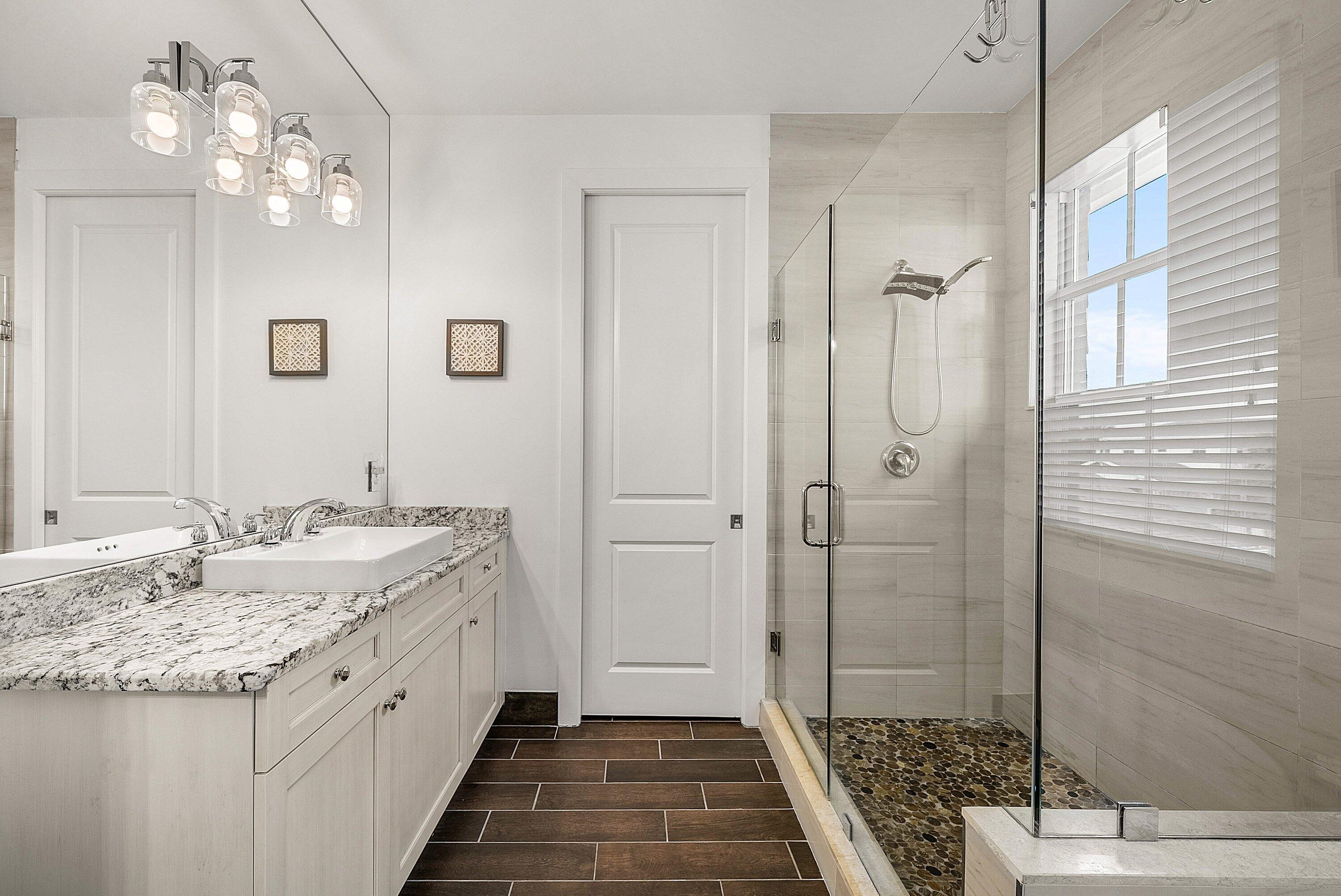 1107 Timber Reap Trail Loxahatchee, FL 33470 - Photo 29 of 83 a spacious bathroom with a granite countertop sink a mirror and shower