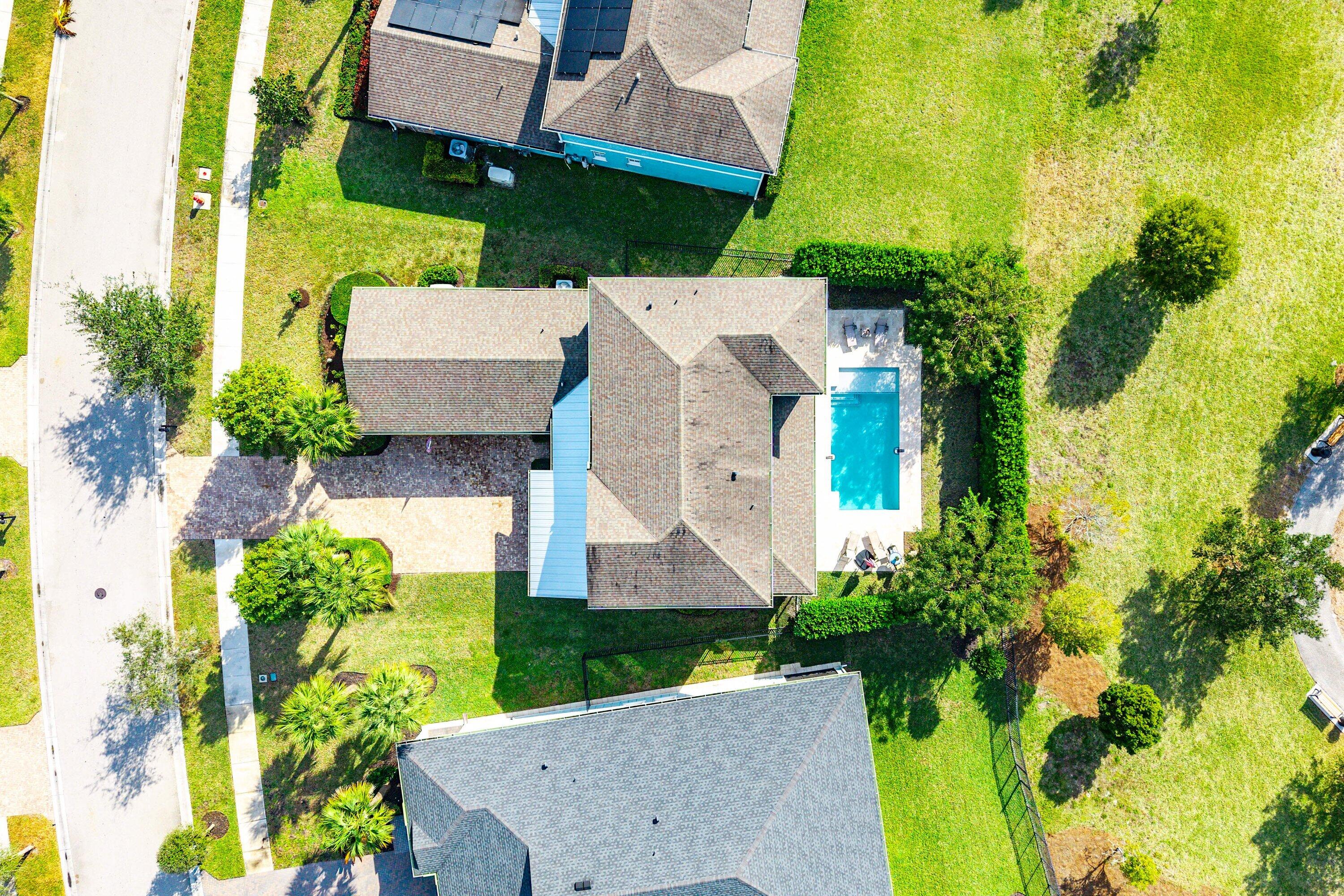 1107 Timber Reap Trail Loxahatchee, FL 33470 - Photo 45 of 83 an aerial view of a house with a yard and large trees
