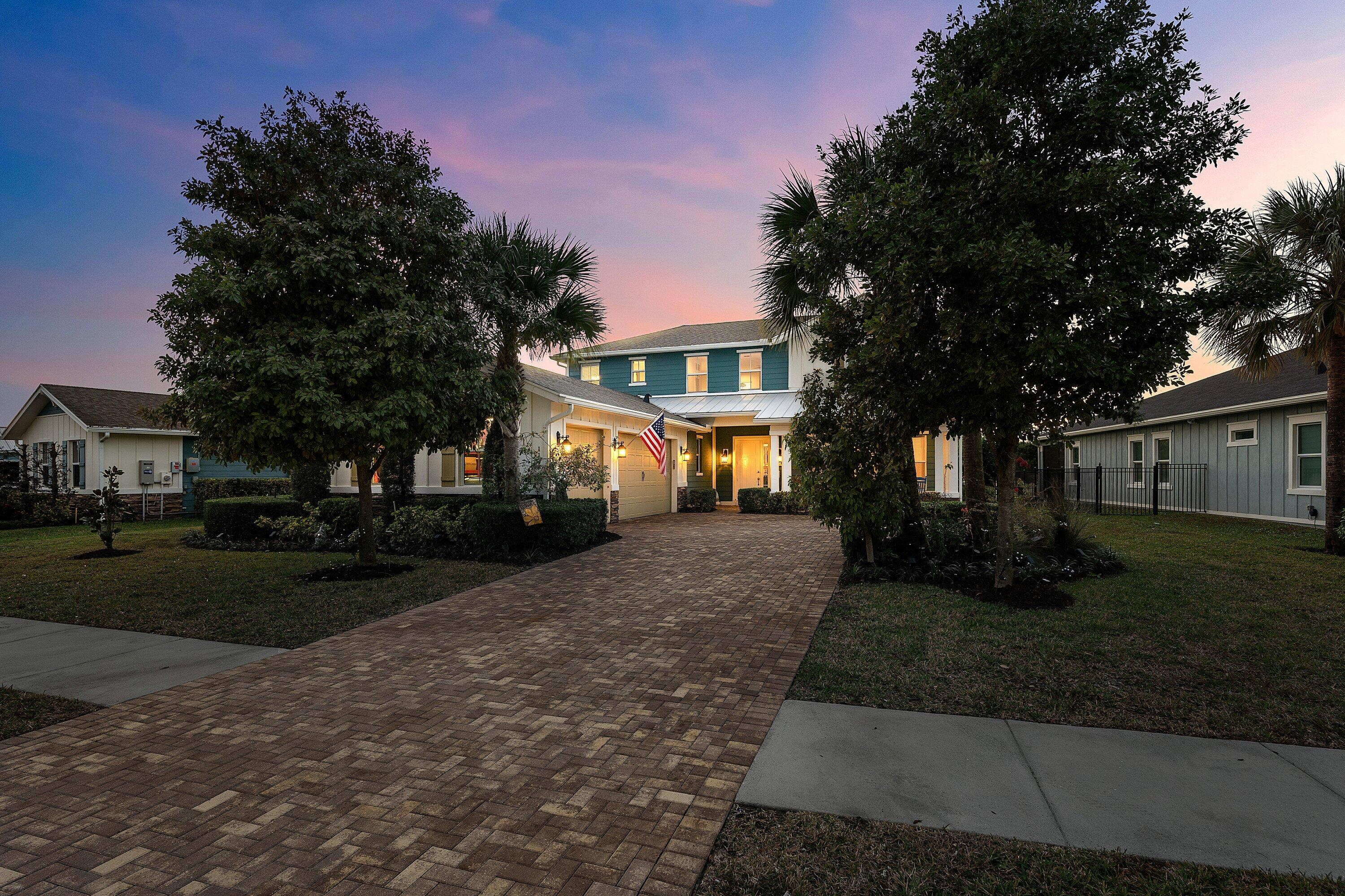 1107 Timber Reap Trail Loxahatchee, FL 33470 - Photo 55 of 83 a front view of a house with a yard and tree s