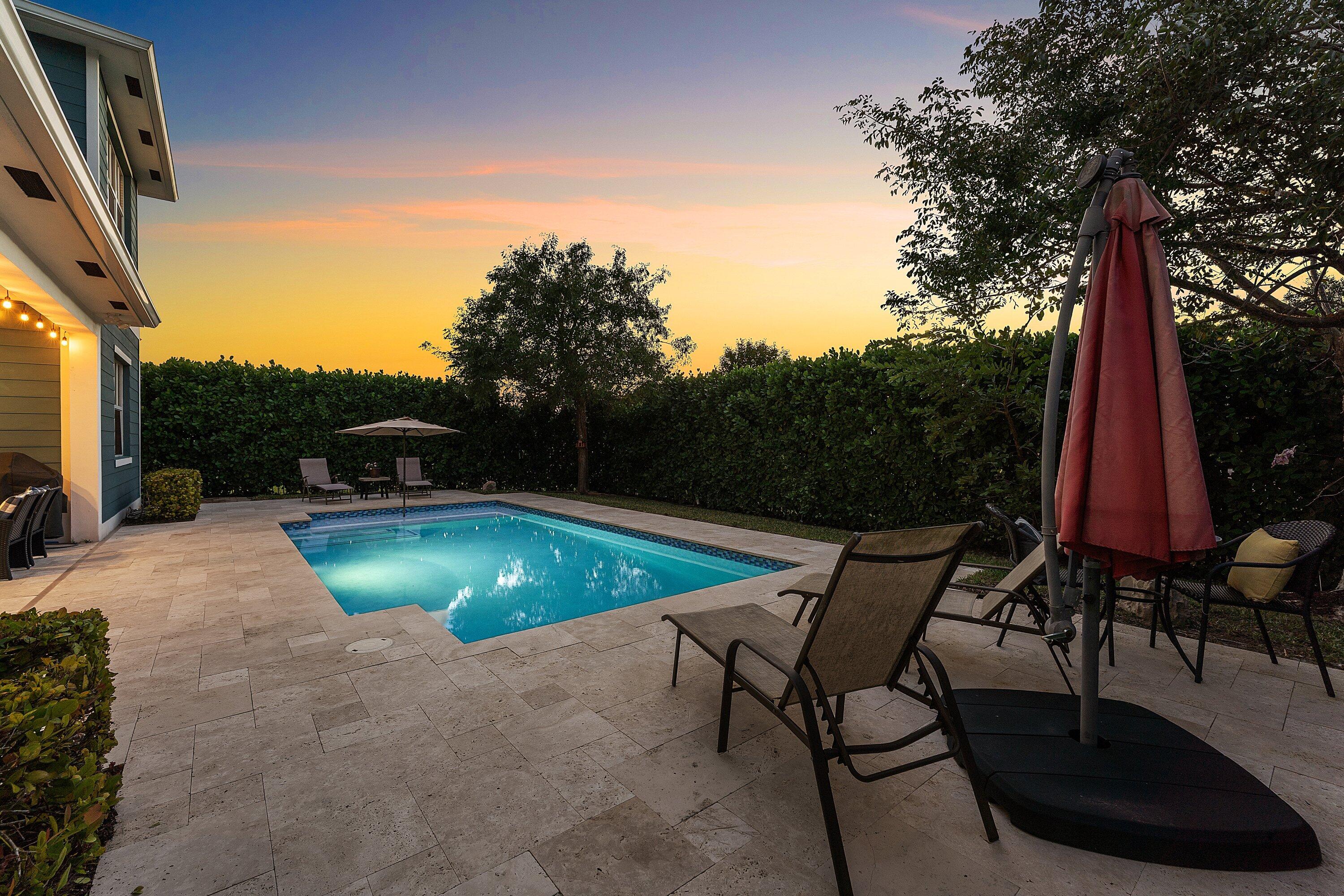 1107 Timber Reap Trail Loxahatchee, FL 33470 - Photo 58 of 83 a view of a swimming pool with a lounge chair and a small yard