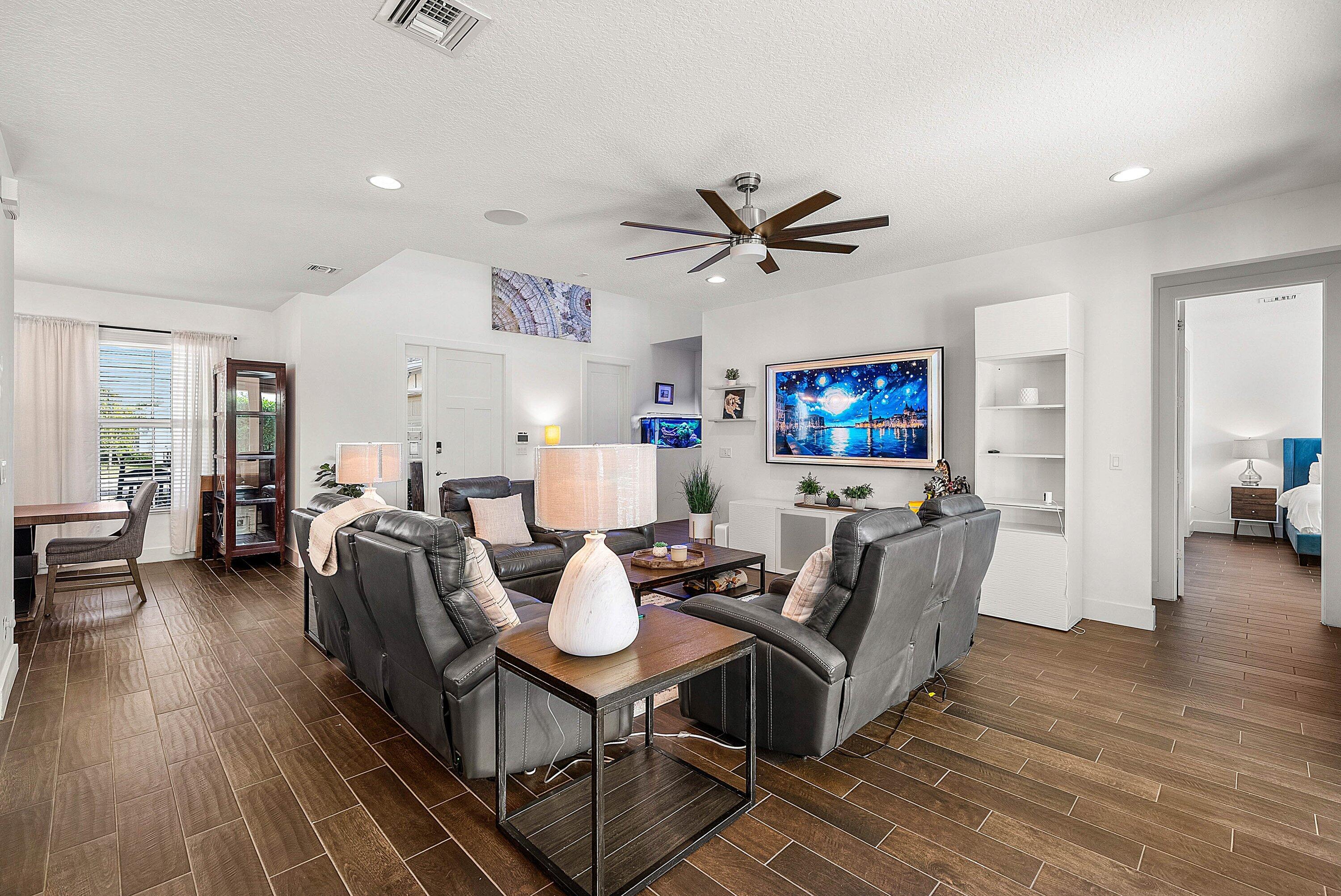 1107 Timber Reap Trail Loxahatchee, FL 33470 - Photo 8 of 83 a living room with furniture a flat screen tv and wooden floor