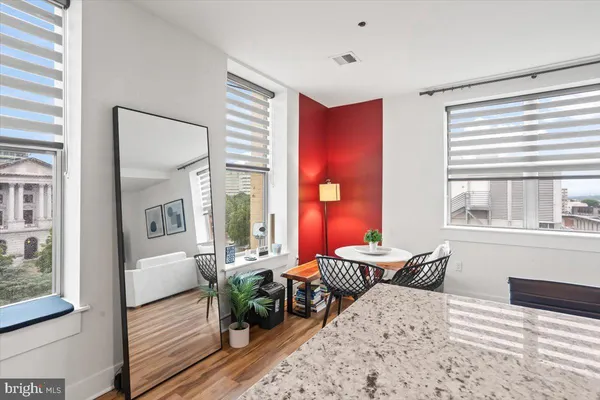 a bedroom with furniture and a large window