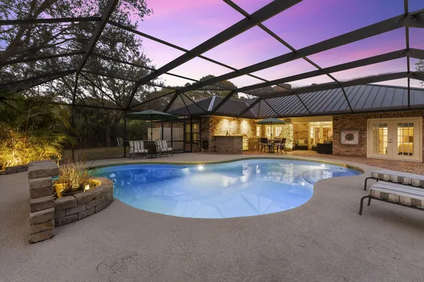 a view of a patio with table and chairs under an umbrella