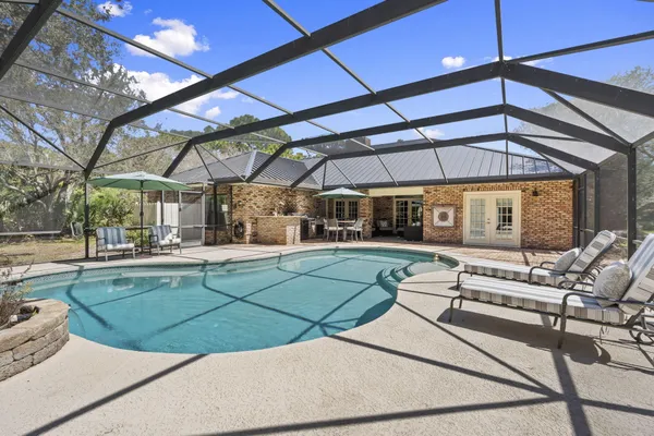 a living room with furniture a clock and a large window