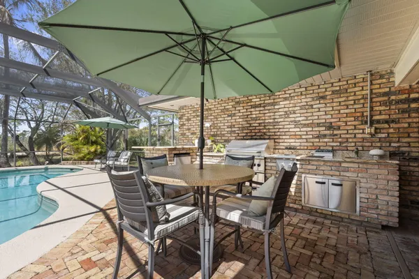 a kitchen with granite countertop a sink and white cabinets