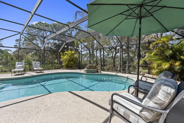 a kitchen with granite countertop white cabinets and stainless steel appliances