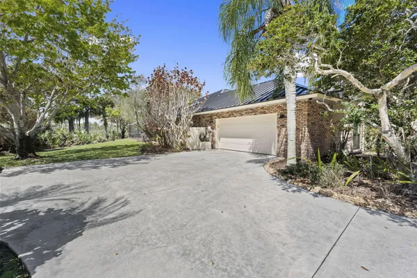 a spacious bedroom with a bed a chair and next to a window